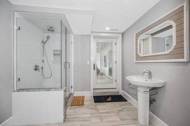 bathroom with sink and an enclosed shower