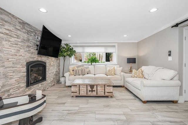 living room with a stone fireplace and ornamental molding