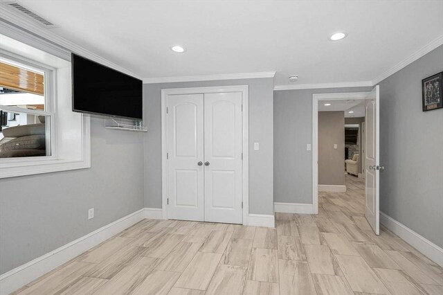 unfurnished bedroom featuring ornamental molding and a closet