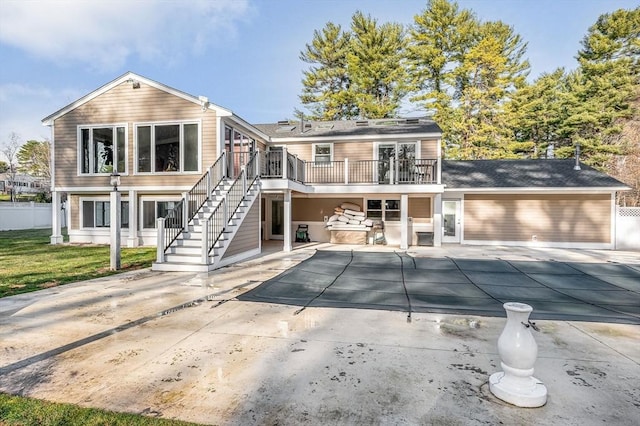 rear view of property featuring a patio and a deck