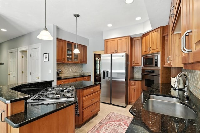 19 Hawthorn Rd, Amherst, MA 01002 - kitchen with appliances with stainless steel finishes, a kitchen island, tasteful backsplash, brown cabinetry, and recessed lighting