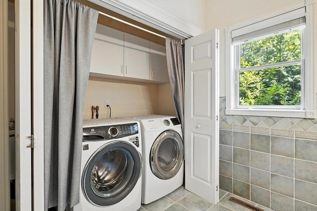 19 Hawthorn Rd, Amherst, MA 01002 - washroom featuring cabinet space, washer and dryer, and light tile patterned flooring