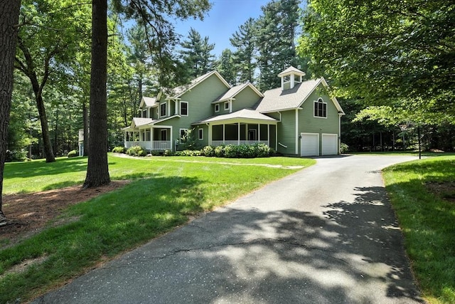 19 Hawthorn Rd, Amherst, MA 01002 - view of front facade featuring an attached garage, asphalt driveway, and a front yard