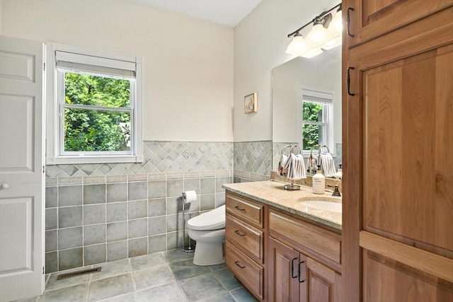 19 Hawthorn Rd, Amherst, MA 01002 - bathroom featuring tile walls, vanity, wainscoting, and tile patterned floors