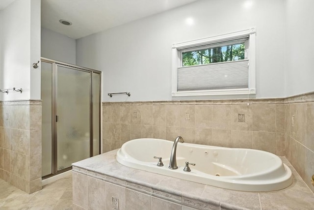 19 Hawthorn Rd, Amherst, MA 01002 - full bathroom featuring a stall shower, a jetted tub, tile walls, wainscoting, and tile patterned floors