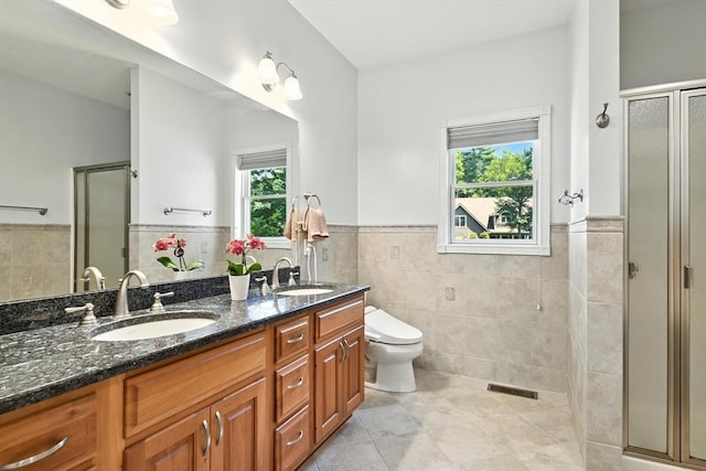 19 Hawthorn Rd, Amherst, MA 01002 - bathroom featuring tile walls, tile patterned flooring, wainscoting, a stall shower, and double vanity