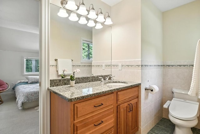 19 Hawthorn Rd, Amherst, MA 01002 - ensuite bathroom with vanity, tile walls, and wainscoting