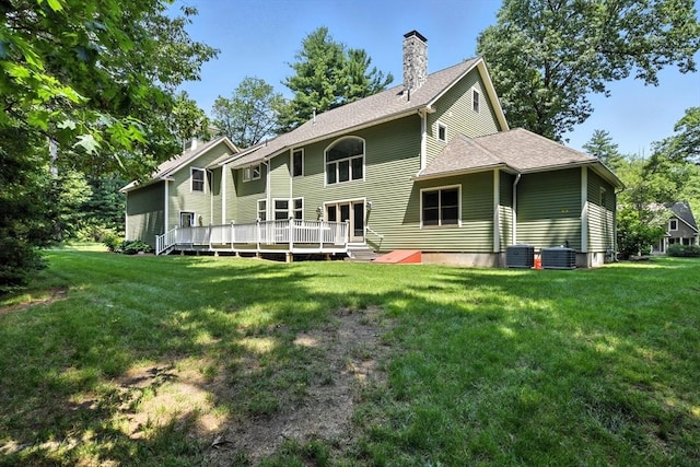 19 Hawthorn Rd, Amherst, MA 01002 - back of property with a wooden deck, a chimney, a yard, and roof with shingles