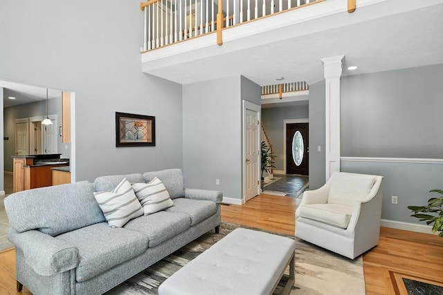 19 Hawthorn Rd, Amherst, MA 01002 - living room featuring a towering ceiling, light wood-type flooring, ornate columns, and recessed lighting
