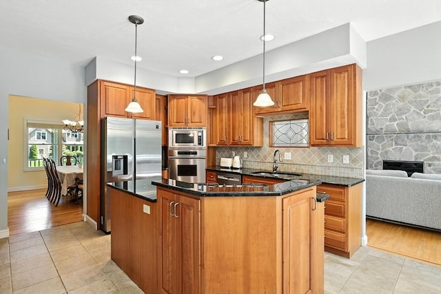 19 Hawthorn Rd, Amherst, MA 01002 - kitchen with stainless steel appliances, light tile patterned floors, decorative backsplash, and dark stone counters