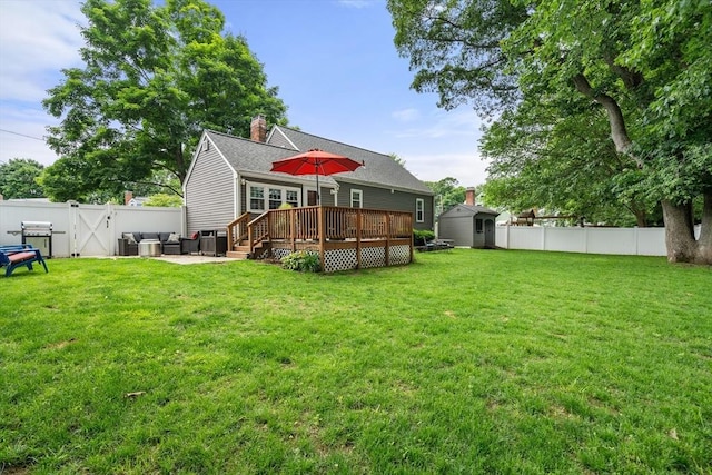 99 Edgehill Rd, Norwood, MA 02062 - rear view of property with a storage unit, a wooden deck, a fenced backyard, a chimney, and a gate