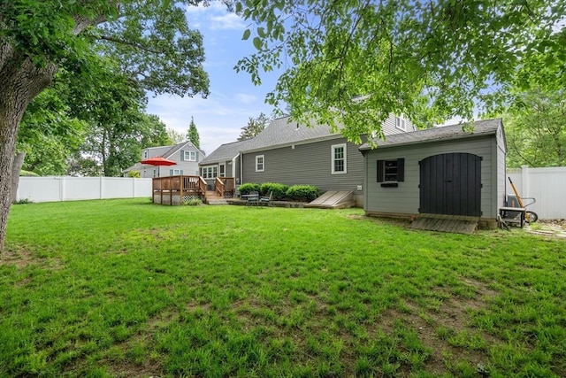 99 Edgehill Rd, Norwood, MA 02062 - back of property featuring a wooden deck, a fenced backyard, and a storage shed