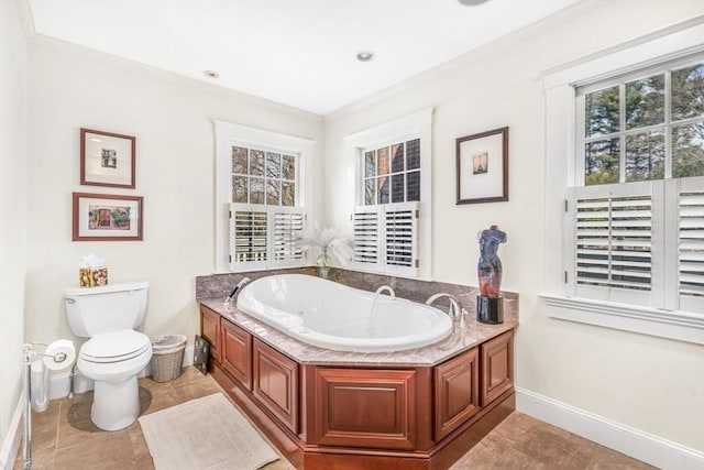 bathroom featuring toilet, baseboards, ornamental molding, and a bath