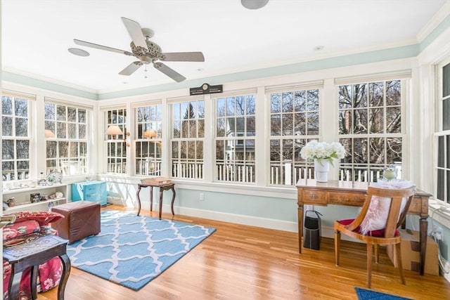 sunroom featuring ceiling fan and a healthy amount of sunlight