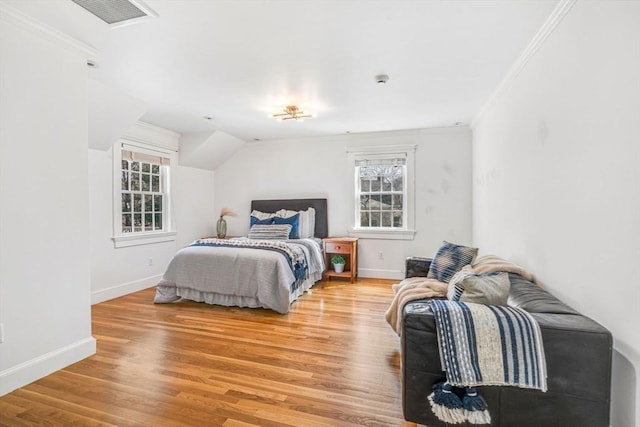 bedroom with light wood-type flooring, visible vents, and baseboards