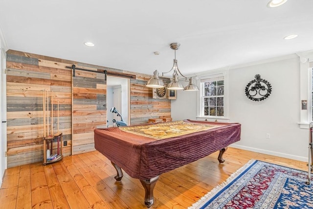 playroom featuring a barn door, billiards, baseboards, light wood-style floors, and wood walls