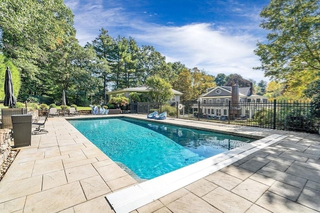 view of swimming pool with a patio area, fence, and a fenced in pool