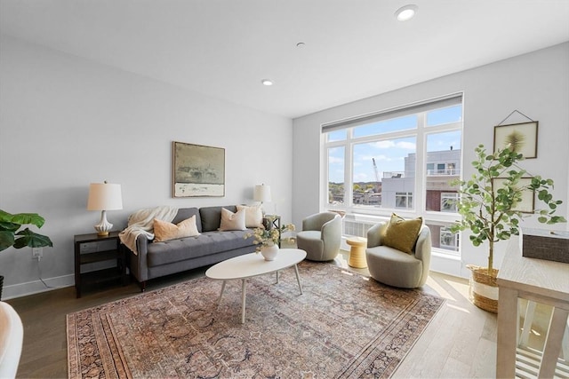 living area featuring wood finished floors, recessed lighting, and baseboards