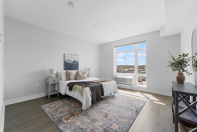 bedroom with wood finished floors and baseboards