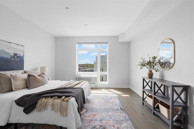 bedroom with baseboards and wood finished floors