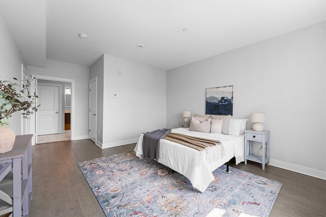 bedroom with wood finished floors and baseboards