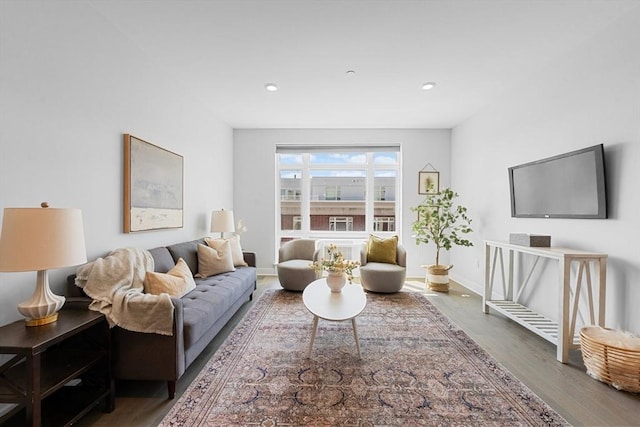 living area featuring wood finished floors, recessed lighting, and baseboards