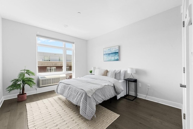 bedroom with baseboards and dark wood-style floors