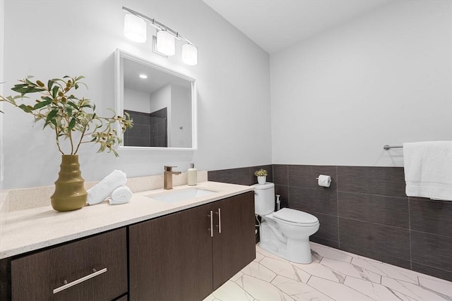 full bath featuring toilet, tile walls, and vanity