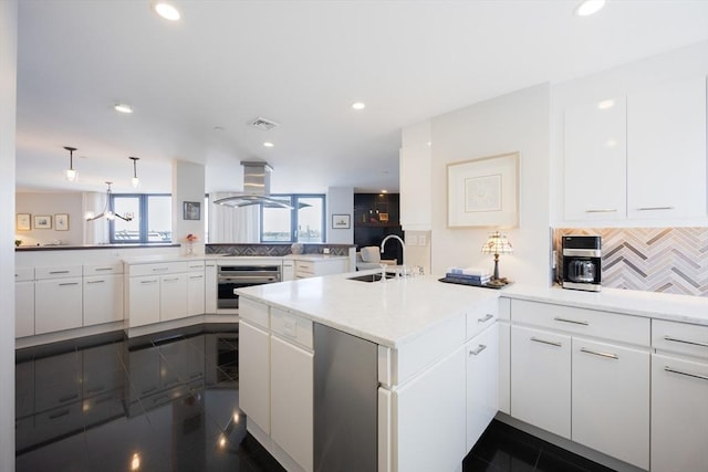 2001 Marina Dr Unit 707, Quincy, MA 02171 - kitchen featuring a peninsula, a sink, oven, island range hood, and white cabinetry