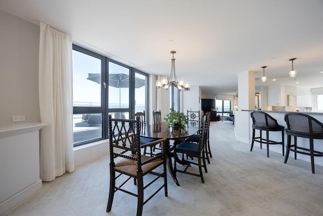 2001 Marina Dr Unit 707, Quincy, MA 02171 - dining space with light colored carpet, baseboards, and a chandelier