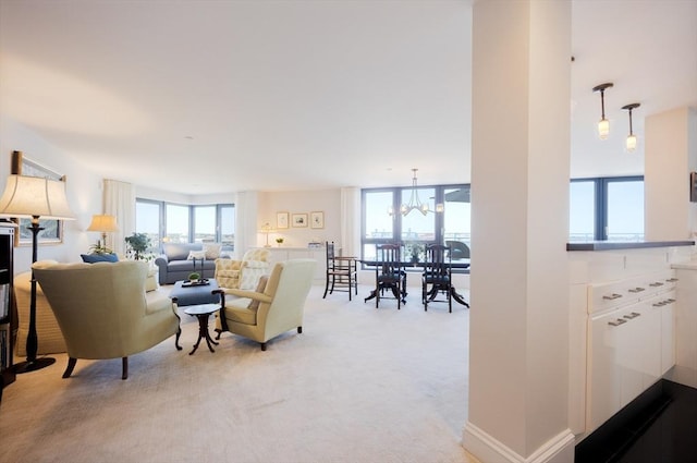 2001 Marina Dr Unit 707, Quincy, MA 02171 - living area featuring plenty of natural light, light colored carpet, and a chandelier