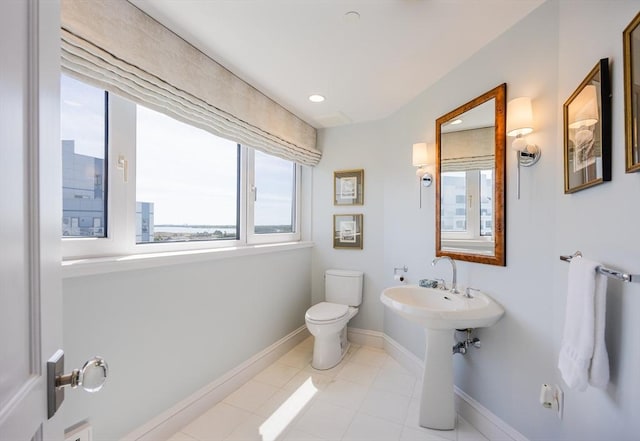 2001 Marina Dr Unit 707, Quincy, MA 02171 - bathroom featuring plenty of natural light, toilet, baseboards, and tile patterned flooring