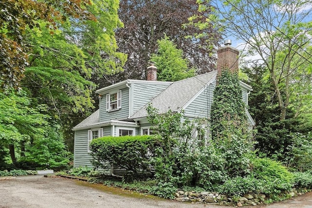 14 Upland Rd, Andover, MA 01810 - view of property exterior with a chimney and a shingled roof
