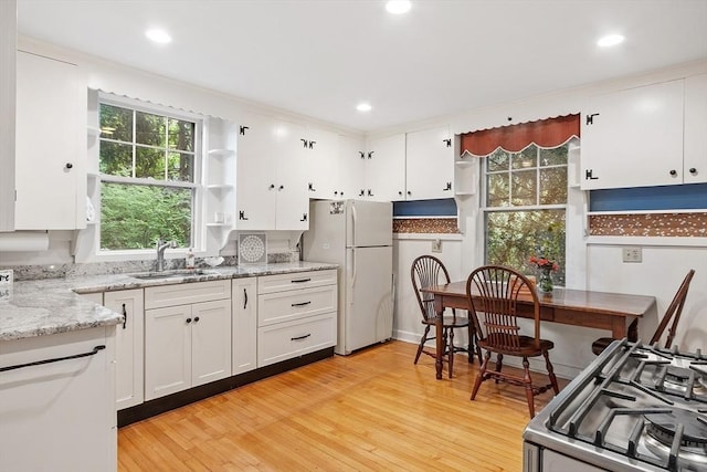 14 Upland Rd, Andover, MA 01810 - kitchen with freestanding refrigerator, stove, open shelves, healthy amount of natural light, and recessed lighting