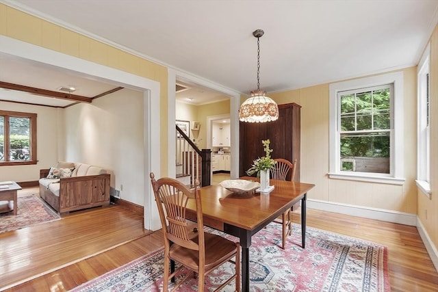 14 Upland Rd, Andover, MA 01810 - dining space with light wood-type flooring, plenty of natural light, stairs, and crown molding
