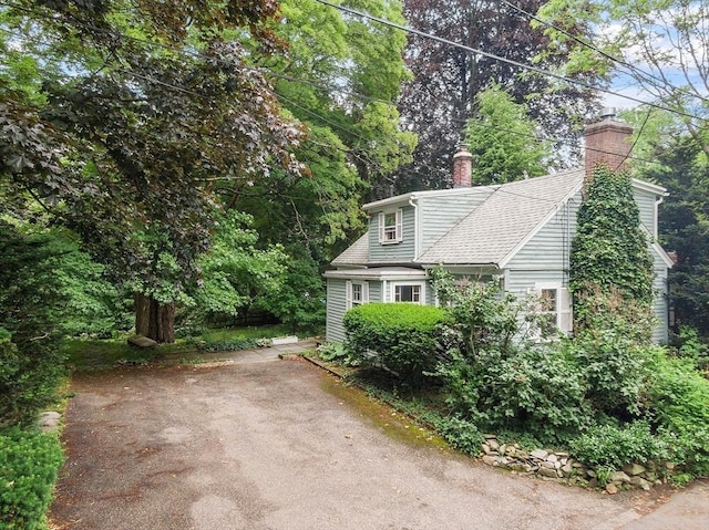 14 Upland Rd, Andover, MA 01810 - view of side of home with a chimney and roof with shingles