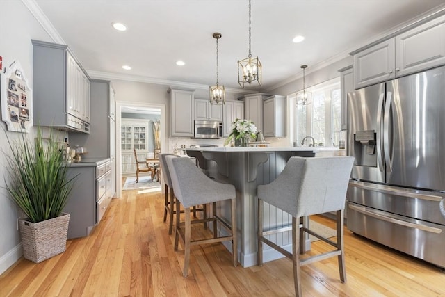 kitchen featuring ornamental molding, gray cabinets, stainless steel appliances, light hardwood / wood-style floors, and decorative backsplash