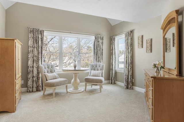 sitting room featuring light carpet and vaulted ceiling