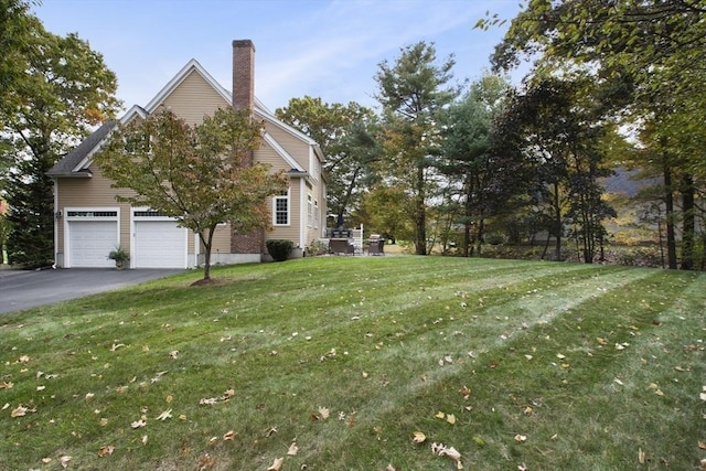 view of home's exterior featuring a garage and a yard