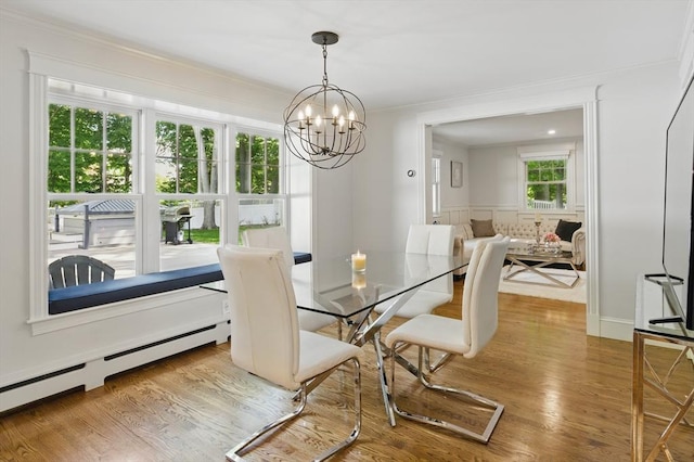 290 Lyman Rd, Milton, MA 02186 - dining room with a chandelier, wood finished floors, a baseboard radiator, and crown molding