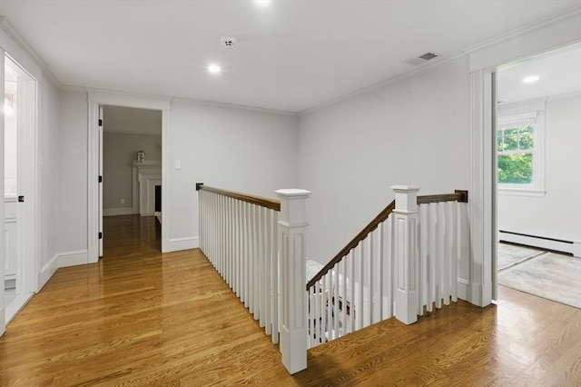 290 Lyman Rd, Milton, MA 02186 - corridor featuring an upstairs landing, light wood-style flooring, a baseboard radiator, ornamental molding, and recessed lighting