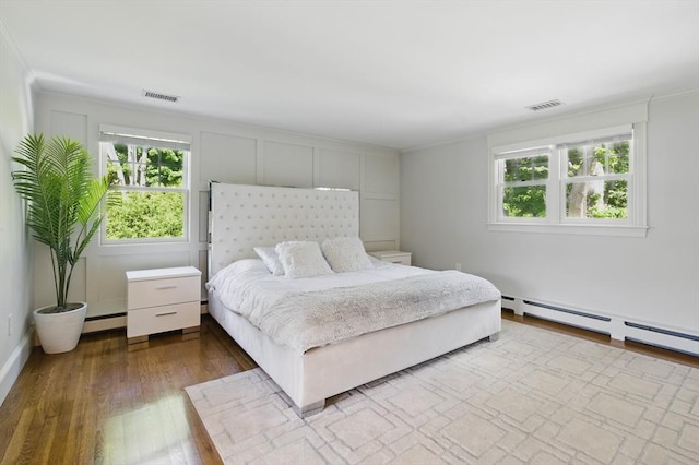 290 Lyman Rd, Milton, MA 02186 - bedroom with wood finished floors, a baseboard heating unit, and ornamental molding