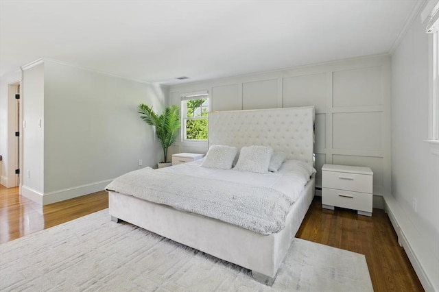 290 Lyman Rd, Milton, MA 02186 - bedroom featuring wood finished floors, crown molding, baseboards, and a decorative wall