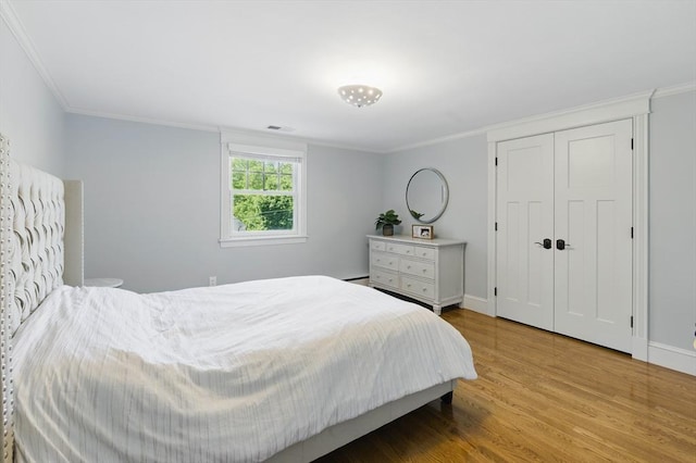 290 Lyman Rd, Milton, MA 02186 - bedroom with wood finished floors, crown molding, baseboards, a baseboard radiator, and a closet