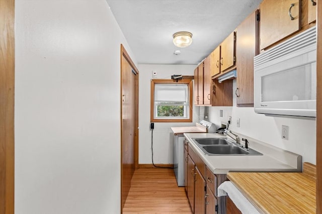 492 N End Blvd, Salisbury, MA 01952 - kitchen featuring white microwave, light wood-type flooring, light countertops, and brown cabinets