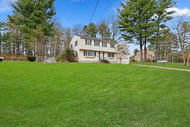 colonial-style house featuring a front lawn