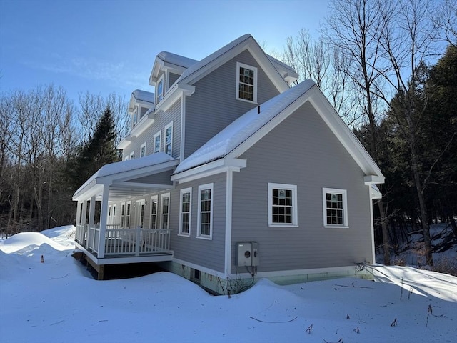 view of snow covered exterior featuring a porch