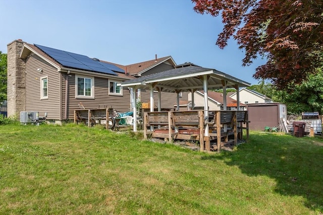 101 Primrose St, Fall River, MA 02720 - back of house with a gazebo, solar panels, a lawn, and a chimney