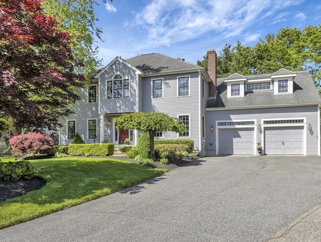 20 Quarry Ln, Easton, MA 02356 - colonial-style house featuring a chimney, driveway, an attached garage, a front yard, and roof with shingles