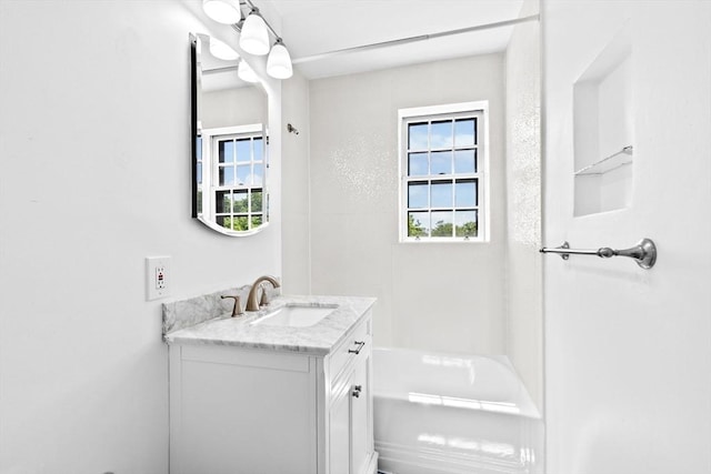 bathroom with vanity and a tub